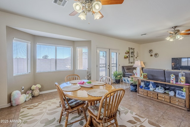 tiled dining area featuring french doors and ceiling fan