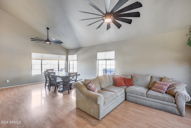 living room featuring light hardwood / wood-style floors, lofted ceiling, plenty of natural light, and ceiling fan