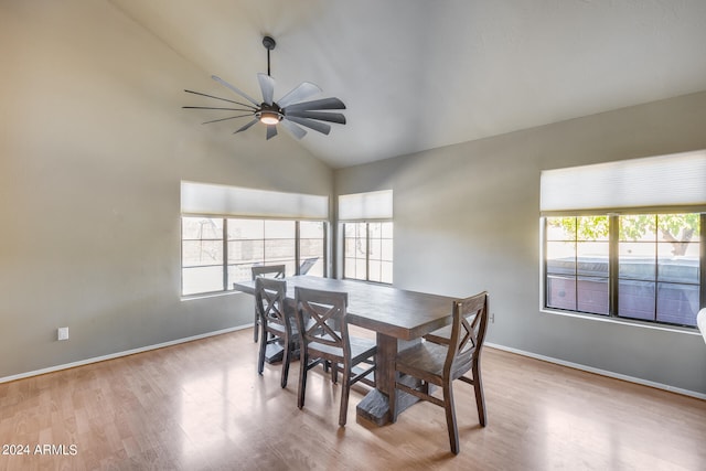 dining space with ceiling fan, lofted ceiling, and light hardwood / wood-style flooring