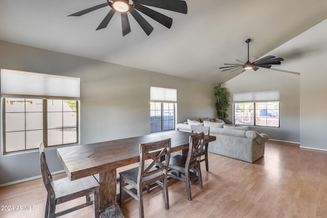 dining space featuring light hardwood / wood-style floors and lofted ceiling