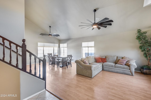 living room with light hardwood / wood-style flooring and high vaulted ceiling