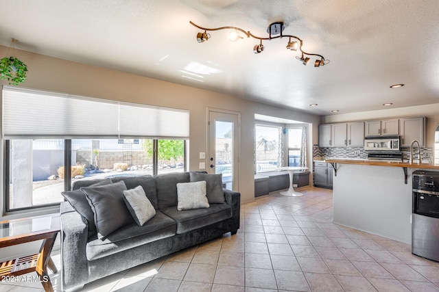 living room featuring a textured ceiling and light tile patterned flooring