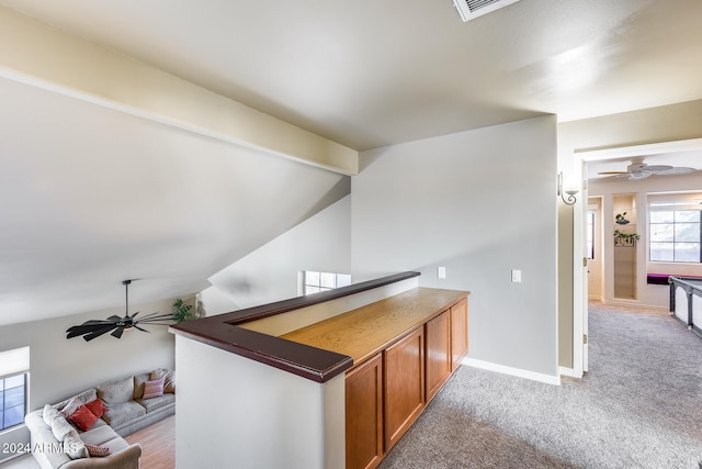 bar with lofted ceiling and light carpet