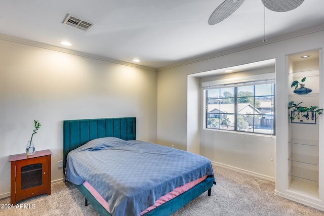 bedroom with ceiling fan, ornamental molding, and carpet floors