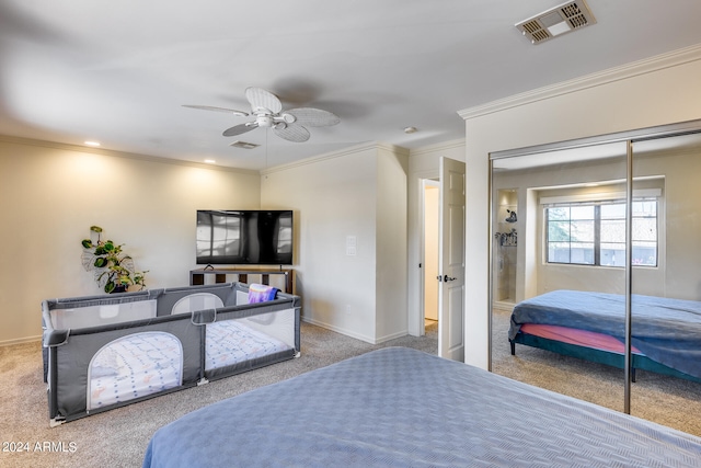 bedroom with a closet, ceiling fan, light carpet, and ornamental molding