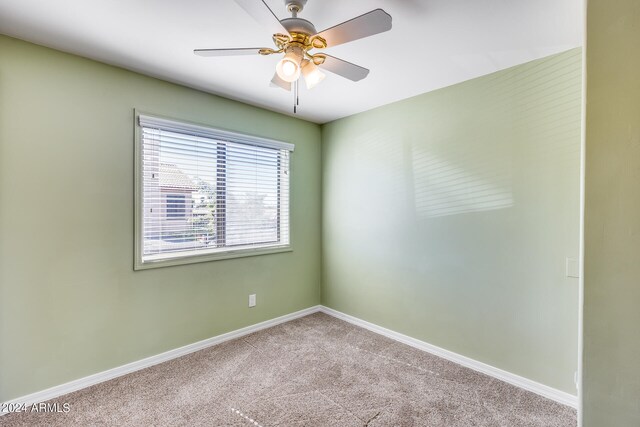 carpeted empty room with ceiling fan