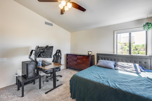 carpeted bedroom with ceiling fan and vaulted ceiling