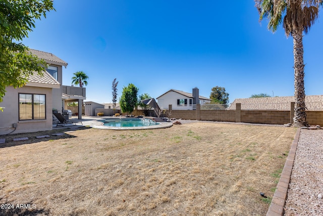 view of yard featuring a patio area and a fenced in pool