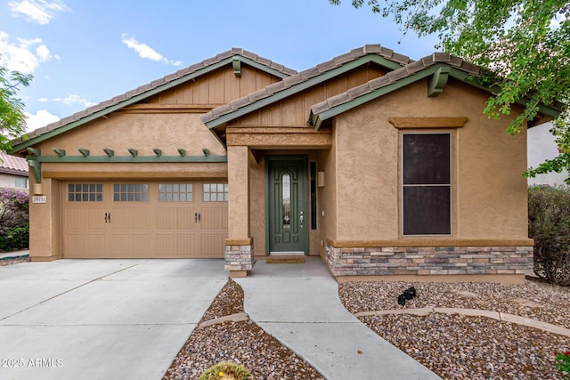 29751 N 119th Ln, Peoria, AZ 85383 - view of front of home featuring an attached garage, concrete driveway, stone siding, and stucco siding