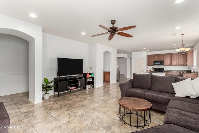 29751 N 119th Ln, Peoria, AZ 85383 - living room with arched walkways, recessed lighting, ceiling fan, and baseboards