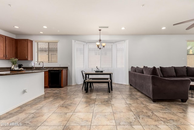 29751 N 119th Ln, Peoria, AZ 85383 - kitchen with dishwasher, dark countertops, a chandelier, recessed lighting, and open floor plan
