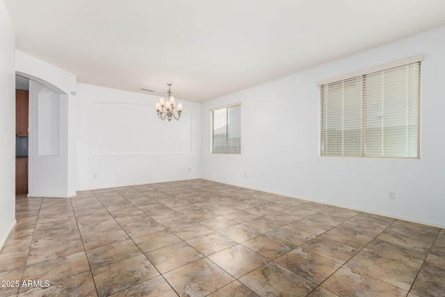 29751 N 119th Ln, Peoria, AZ 85383 - empty room featuring arched walkways and a chandelier