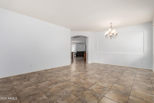 29751 N 119th Ln, Peoria, AZ 85383 - unfurnished room with arched walkways, a chandelier, and baseboards