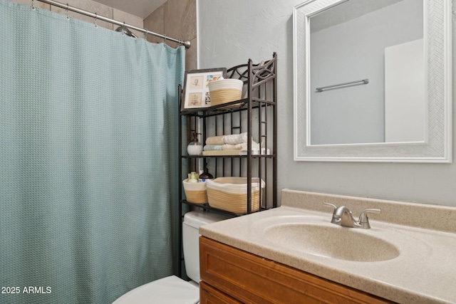 bathroom featuring vanity and toilet