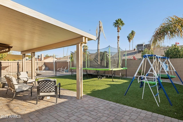 view of patio with a playground and a trampoline