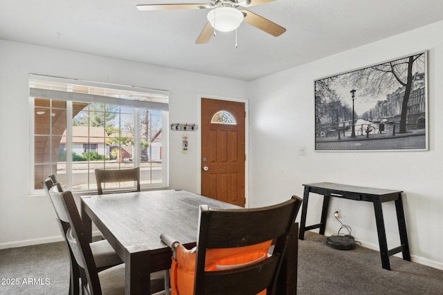 carpeted dining room featuring ceiling fan