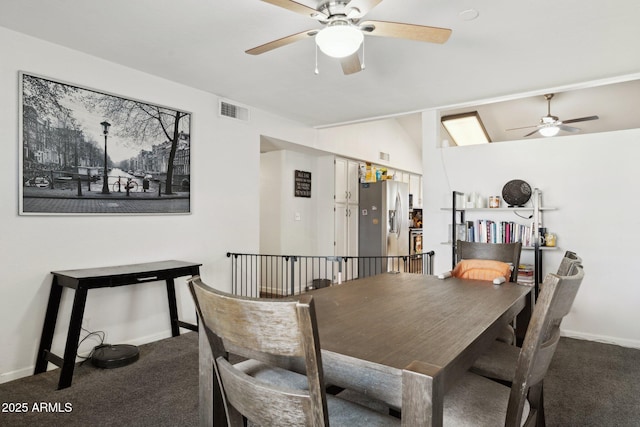 dining room with lofted ceiling, carpet floors, and ceiling fan