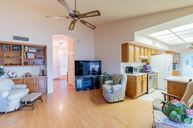 dining room with a notable chandelier, light wood-type flooring, and lofted ceiling