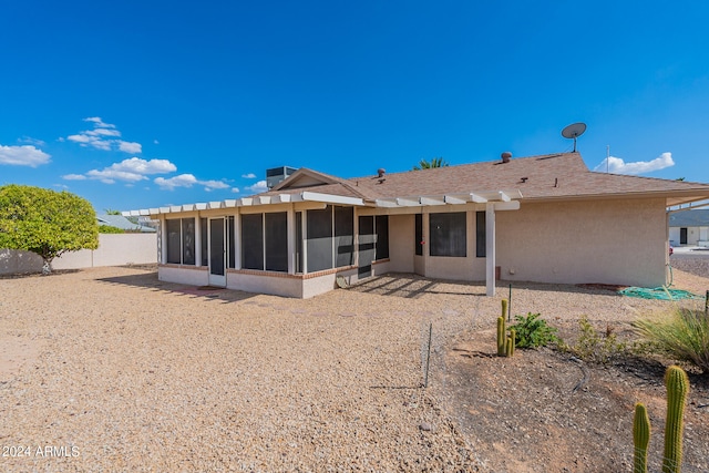 back of property featuring a sunroom and a patio