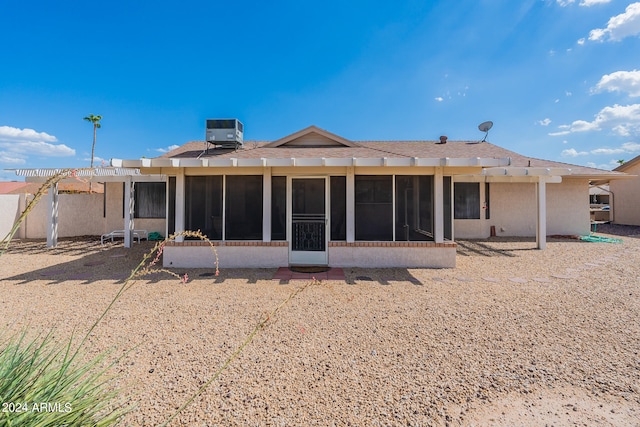 back of house with a sunroom and central AC unit