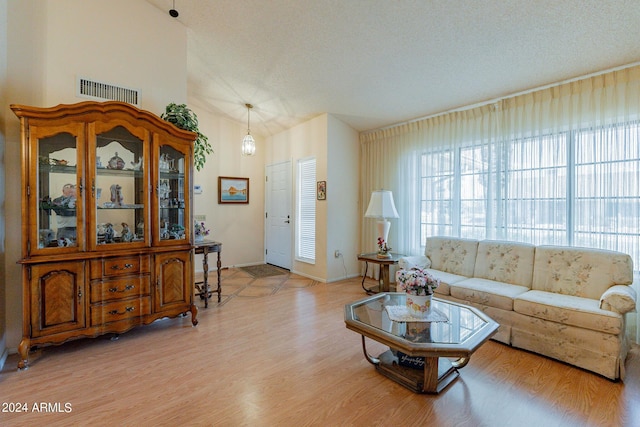 kitchen featuring ceiling fan, white appliances, a high ceiling, and light hardwood / wood-style floors