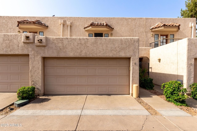 8540 N Central Ave Unit 6, Phoenix, AZ 85020 - pueblo-style house with stucco siding, a garage, and a tiled roof