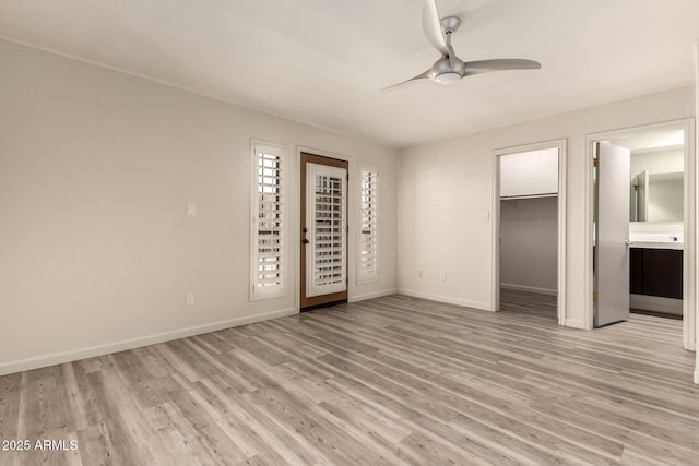 8540 N Central Ave Unit 6, Phoenix, AZ 85020 - unfurnished bedroom with light wood-type flooring, a ceiling fan, a spacious closet, a closet, and ensuite bath
