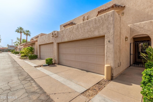 8540 N Central Ave Unit 6, Phoenix, AZ 85020 - view of front of property featuring stucco siding, a garage, and concrete driveway