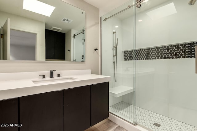 8540 N Central Ave Unit 6, Phoenix, AZ 85020 - bathroom with a shower with shower door, vanity, a skylight, and wood finished floors