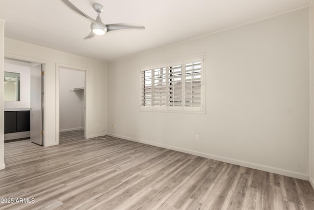 8540 N Central Ave Unit 6, Phoenix, AZ 85020 - unfurnished bedroom with light wood-style floors, a closet, a ceiling fan, and a spacious closet