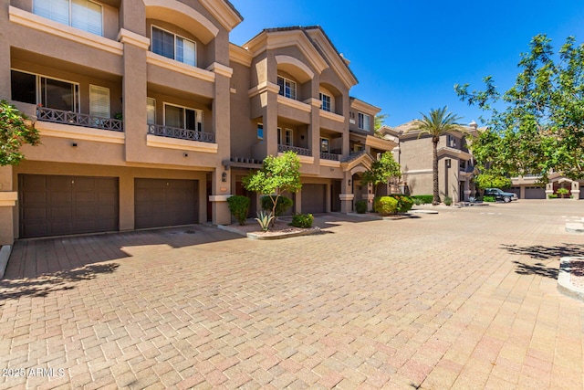 4465 E Paradise Village Pkwy S Unit 1224, Phoenix, AZ 85032 - view of building exterior featuring a garage and driveway
