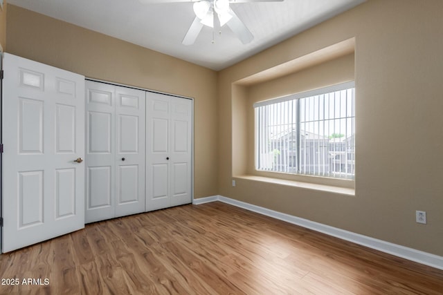 4465 E Paradise Village Pkwy S Unit 1224, Phoenix, AZ 85032 - unfurnished bedroom with wood finished floors, baseboards, a closet, and ceiling fan