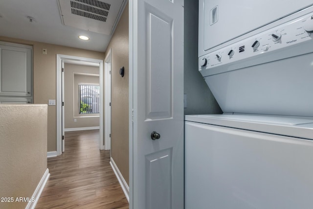 4465 E Paradise Village Pkwy S Unit 1224, Phoenix, AZ 85032 - laundry room featuring estacked washer and dryer, baseboards, wood finished floors, and recessed lighting
