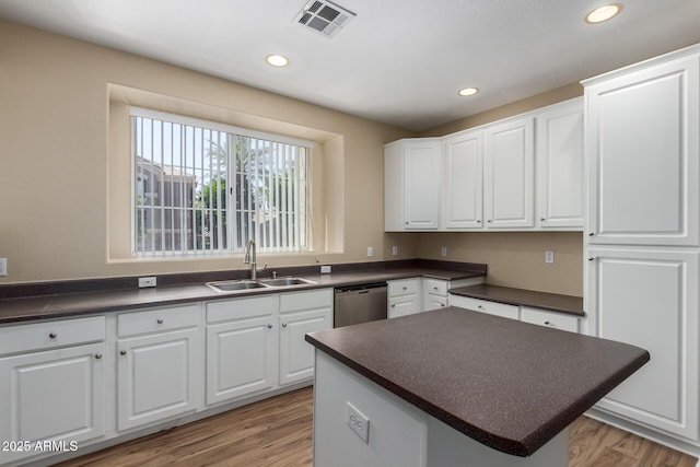 4465 E Paradise Village Pkwy S Unit 1224, Phoenix, AZ 85032 - kitchen featuring a sink, stainless steel dishwasher, dark countertops, recessed lighting, and white cabinets