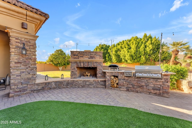view of patio with an outdoor stone fireplace, a grill, fence, and area for grilling