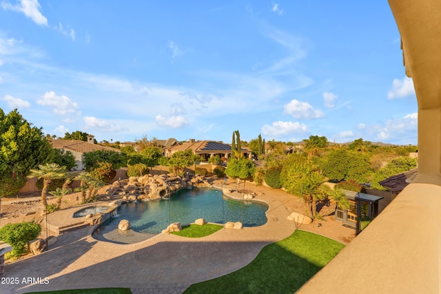 view of pool featuring a fenced backyard, a pool with connected hot tub, and a patio area