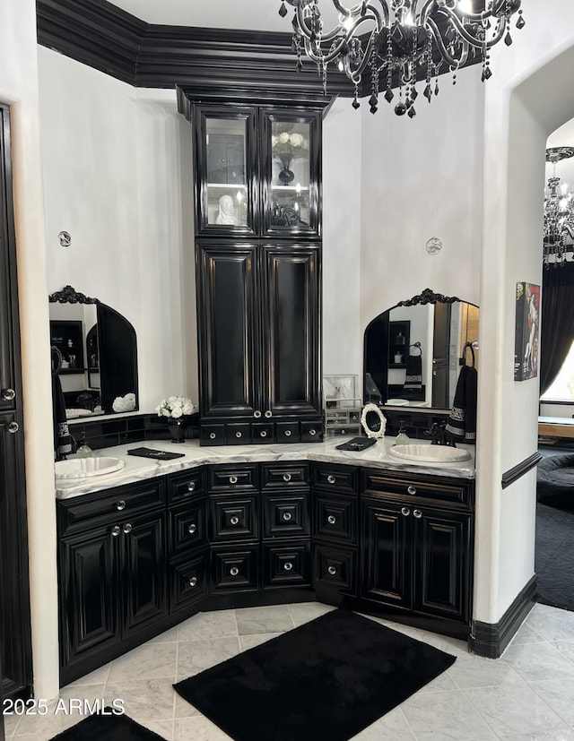 full bathroom with double vanity, a sink, a notable chandelier, and tile patterned floors