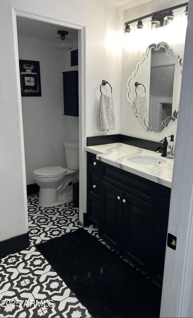 half bathroom featuring toilet and vanity