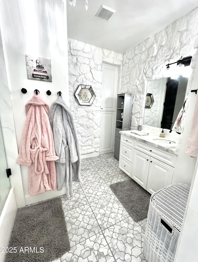 full bathroom with vanity and visible vents
