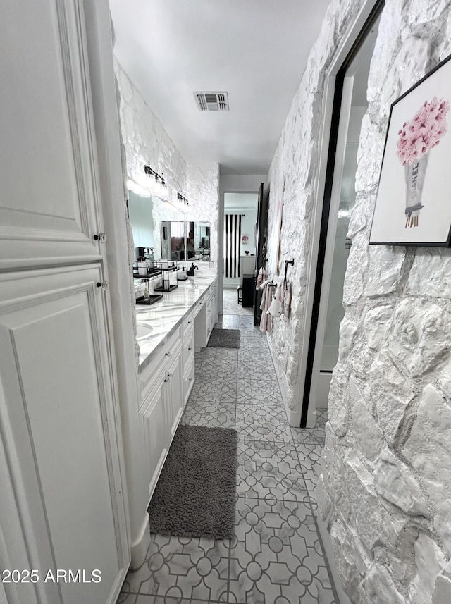 bathroom featuring visible vents and double vanity