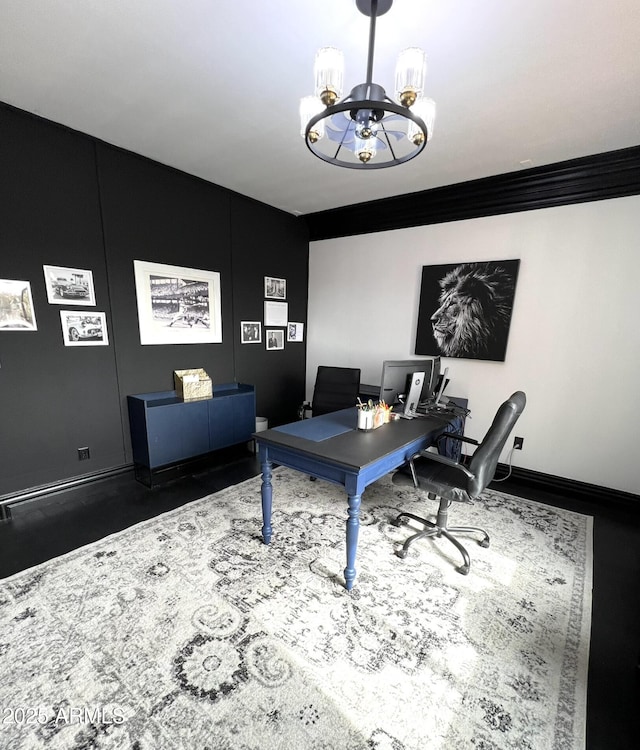 home office featuring baseboards and a chandelier