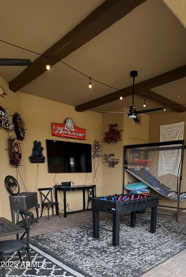rec room featuring beamed ceiling