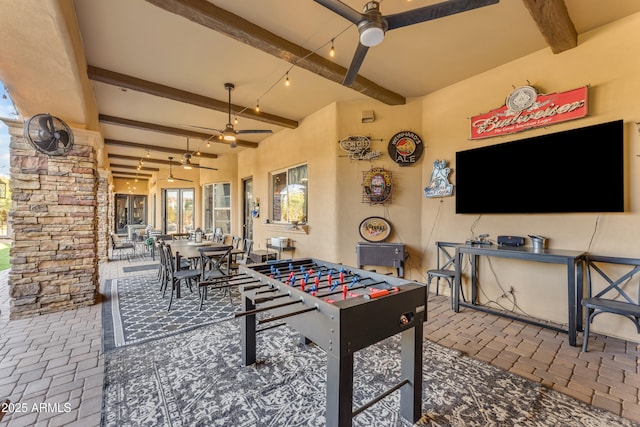 view of patio featuring outdoor dining area and a ceiling fan