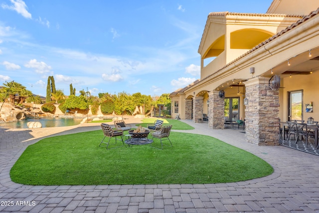 view of yard with a fire pit and a patio area