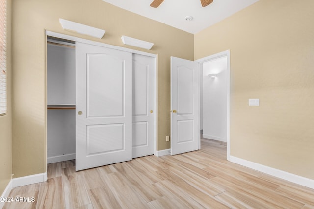 unfurnished bedroom featuring a closet, light hardwood / wood-style flooring, and ceiling fan