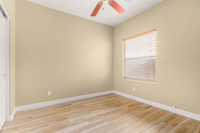 spare room with ceiling fan and light wood-type flooring