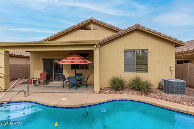 view of swimming pool with central AC and a patio