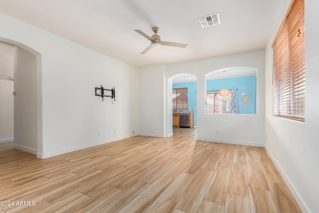 spare room featuring ceiling fan and light wood-type flooring