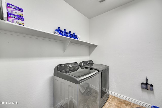 washroom with washing machine and dryer and light tile patterned flooring