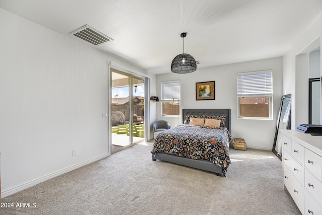 carpeted bedroom featuring access to exterior